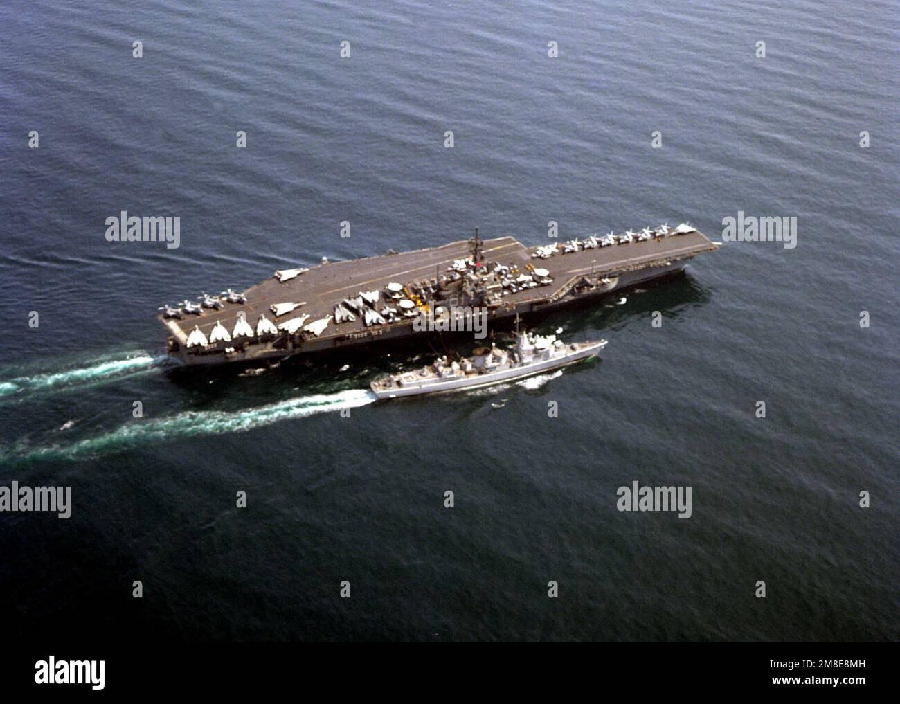 A starboard bow view of the aircraft carrier USS RANGER (CV-61) conducting an underway replenishment with the Dutch frigate Hr Ms Jacob Van Heemskerck (F-812) during Operations Desert Shield/Storm. Subject Operation/Series: DESERT STORMDESERT SHIELD Country: Unknown Stock Photo