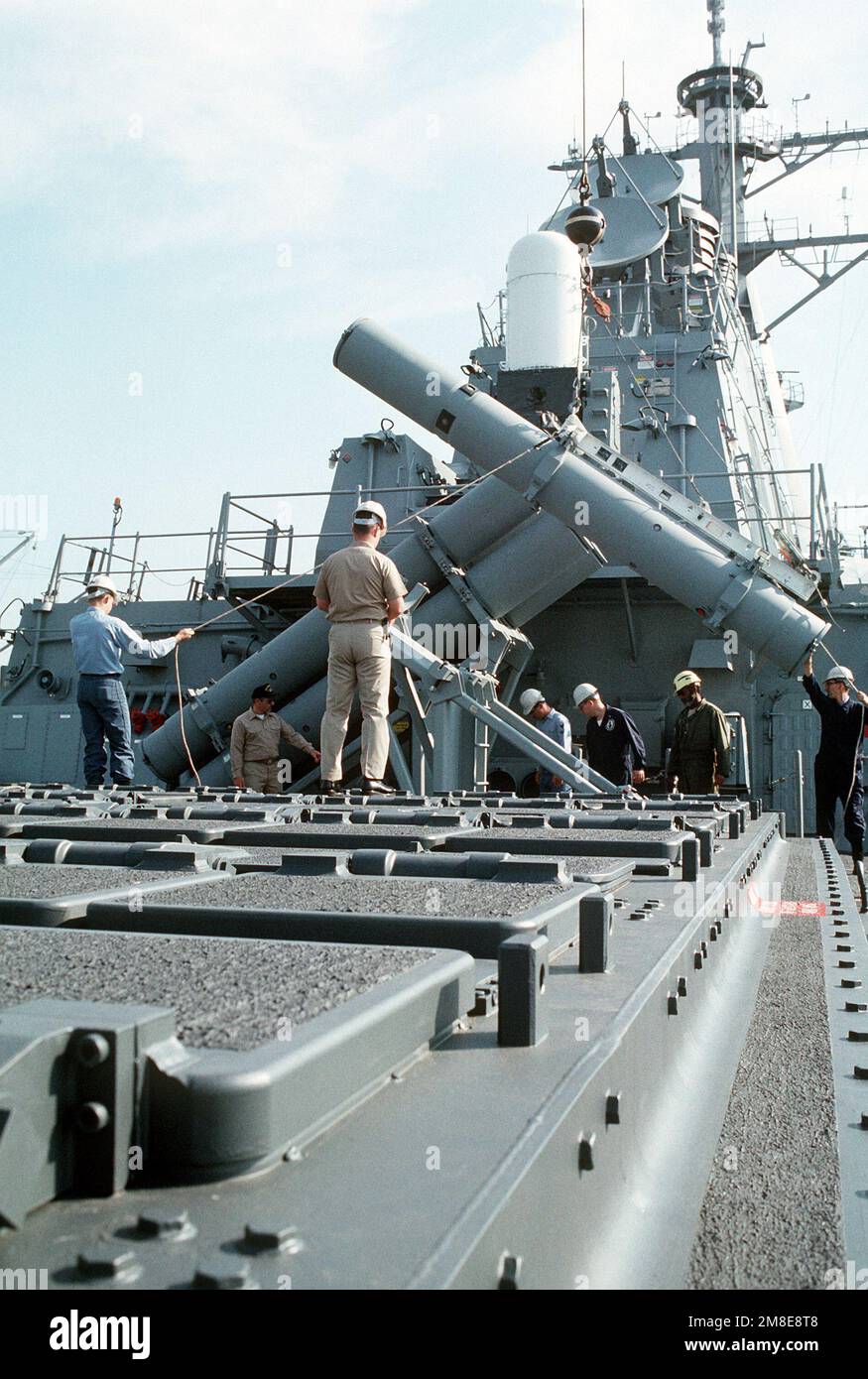 A Harpoon missile canister launcher is lowered into place aboard the