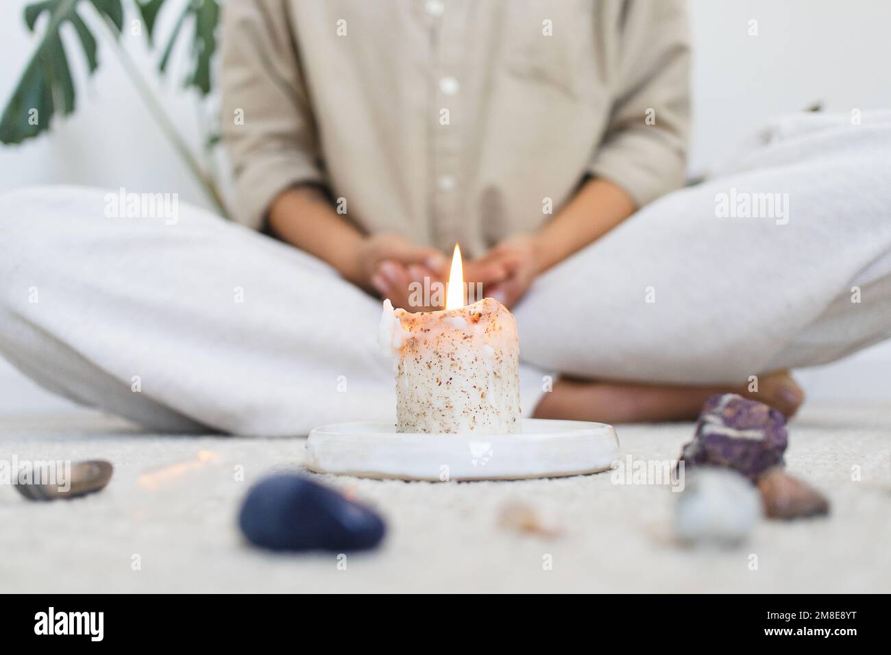 Person Meditating with Candle and Healing Crystals Stock Photo Alamy