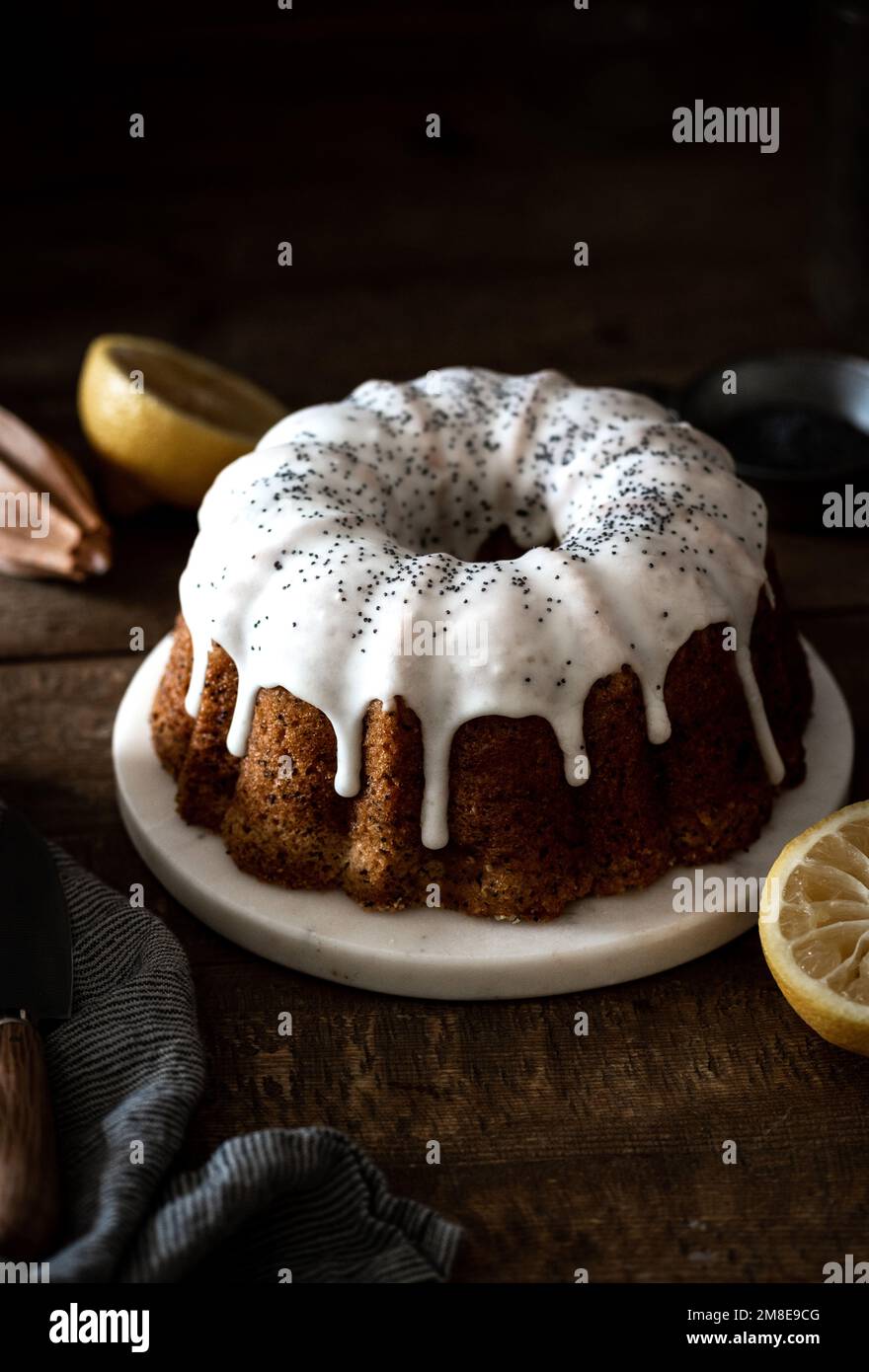 Whole lemon poppy seed cake with drip icing Stock Photo Alamy