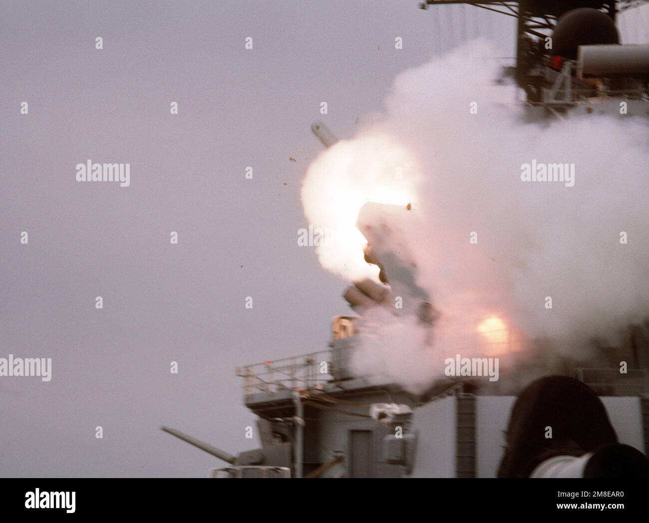A BGM-109 Tomahawk land-attack missile (TLAN) is launched from a Mark 143 armored box launcher (ABL) aboard the battleship USS WISCONSIN (BB-64) during Operation Desert Storm. Subject Operation/Series: DESERT STORM Country: Persian Gulf Stock Photo
