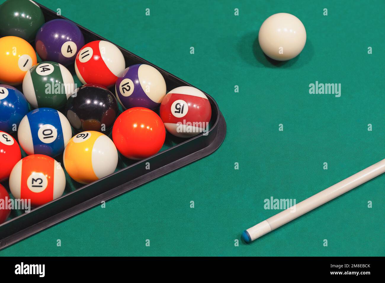 Colorful billiard balls with numbers with cue sticks and rack on blue table Stock Photo Alamy