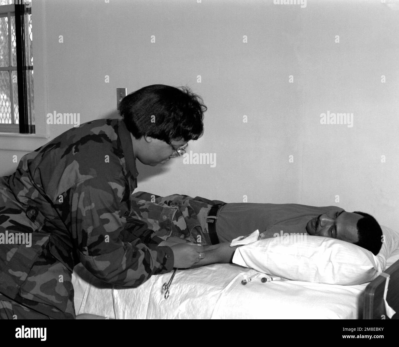 SPEC. Nadine Beach, left, of the 382nd Field Hospital prepares to draw