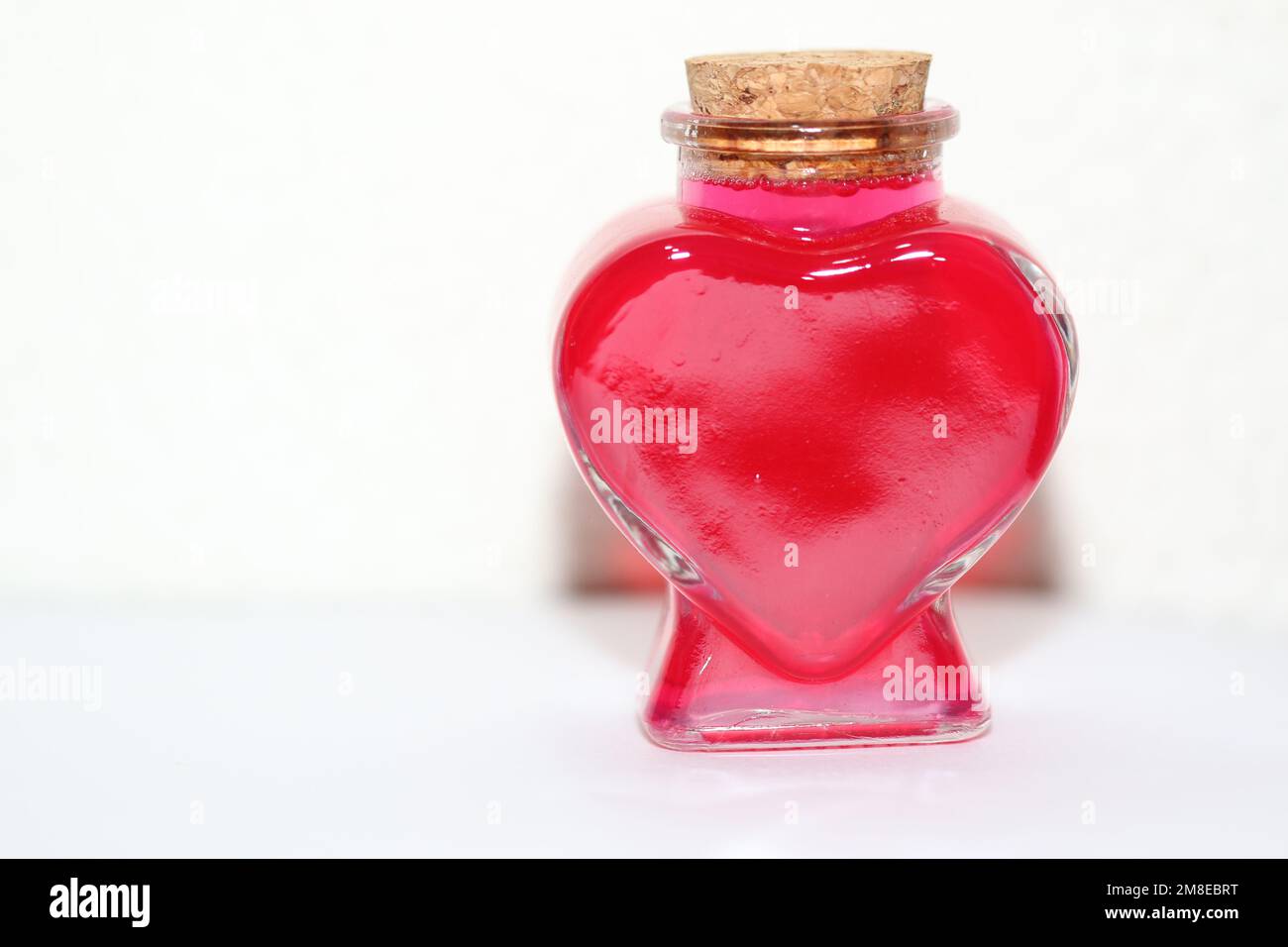 Heart shaped glass container on a white background Stock Photo - Alamy