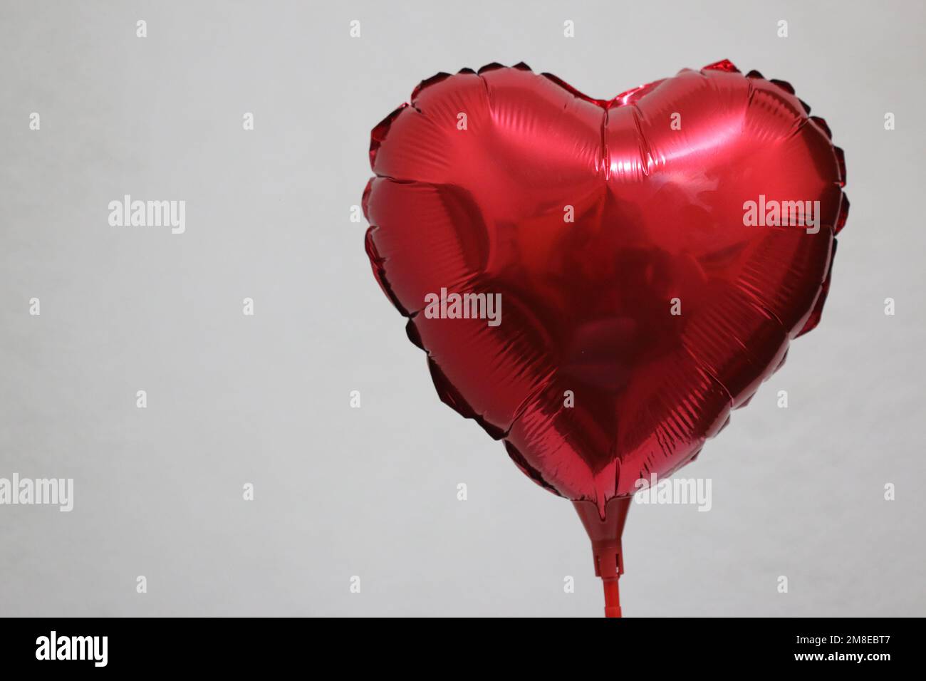 Heart shaped red inflatable balloon Stock Photo