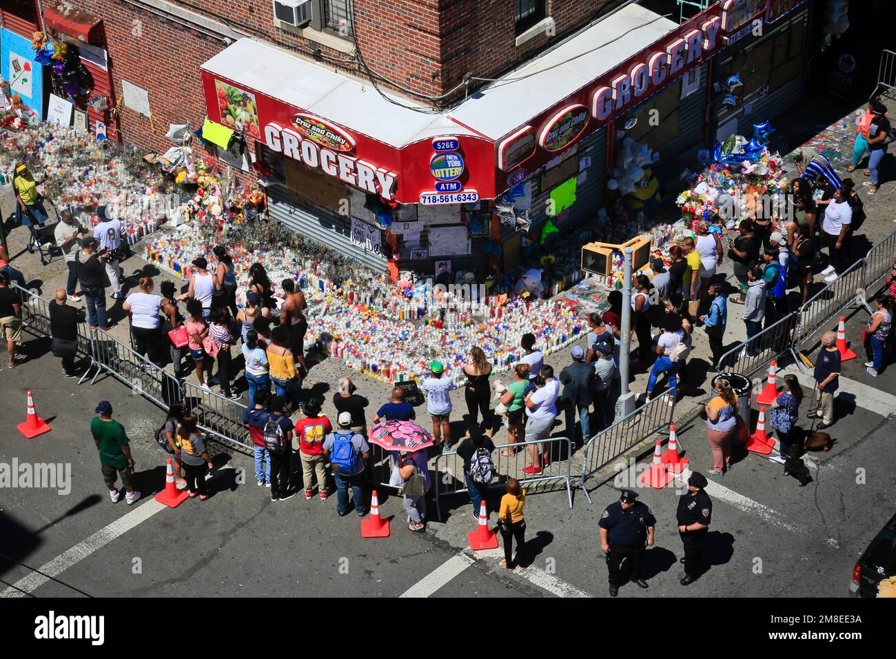 FILE Mouners gather at a community memorial outside a bodega in New