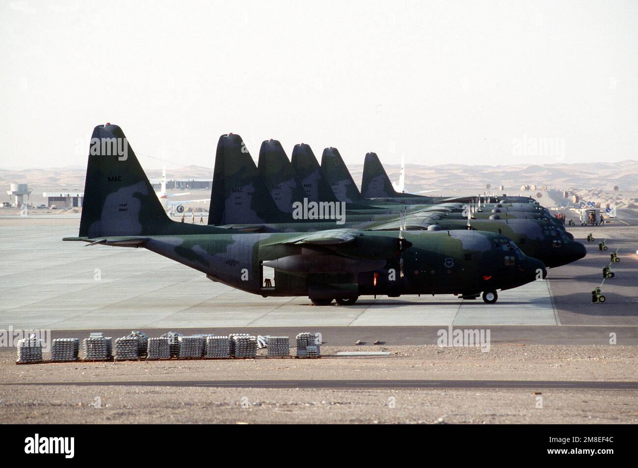 Six C-130 Hercules aircraft sit on the ramp at Landing Zone 32 (LZ-32 ...