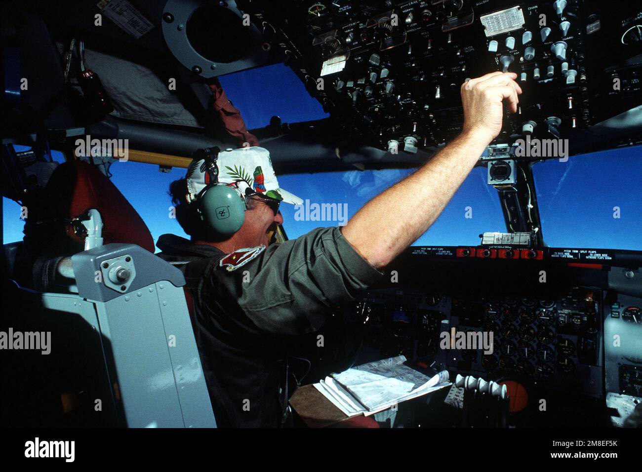 The pilot of a KC135 Stratotanker aircraft monitors equipment in the