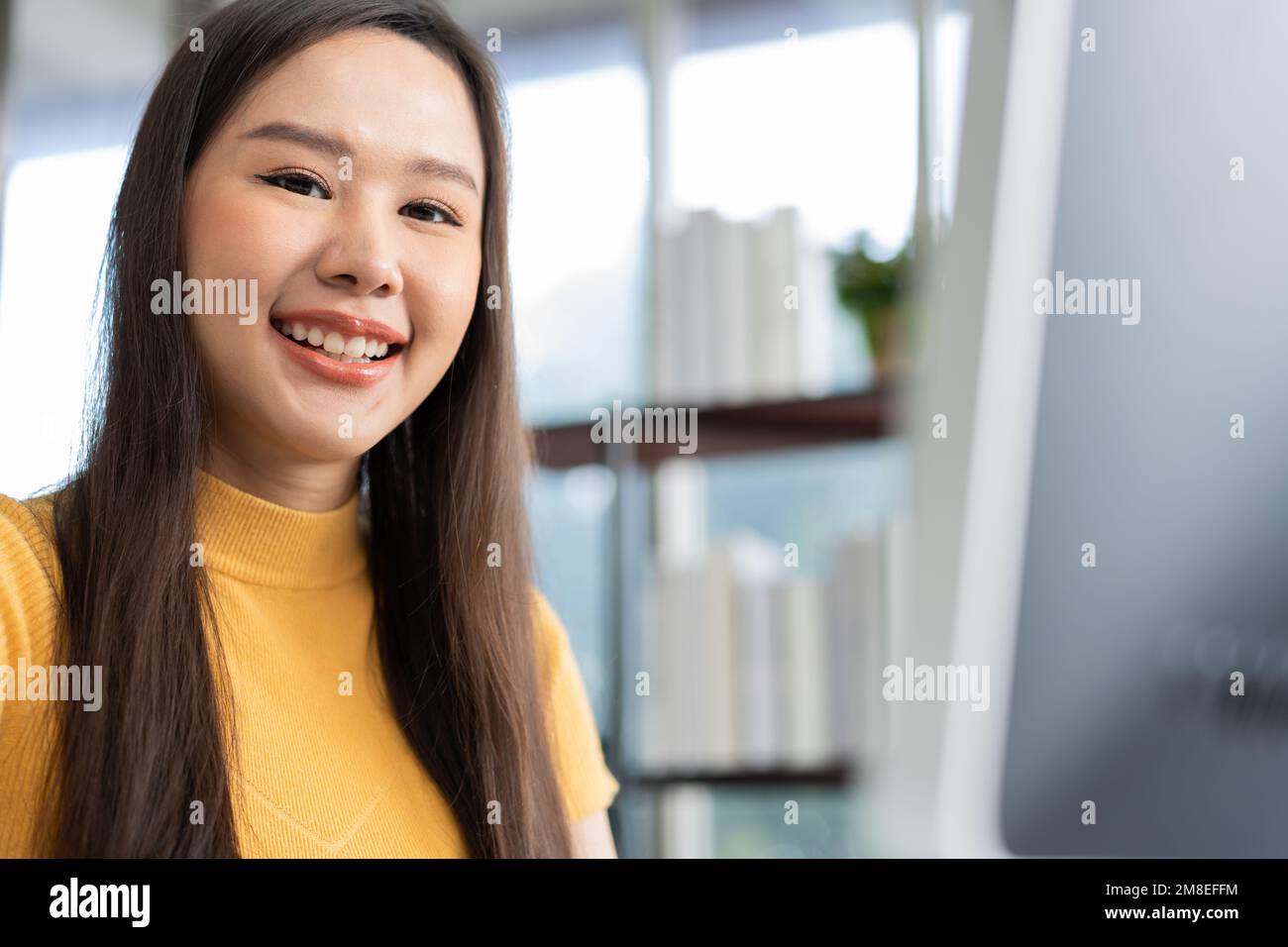 Portrait happy young programmer Asian woman work at start up technology office and using computer for coding application program and fully creative. C Stock Photo