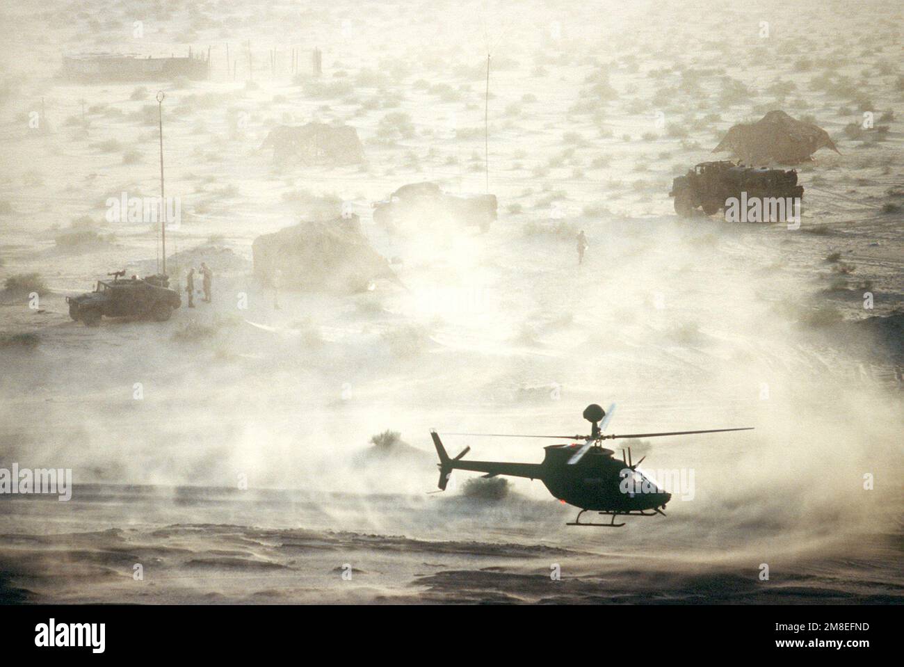 An OH-58D Kiowa helicopter departs from a communications site in the ...