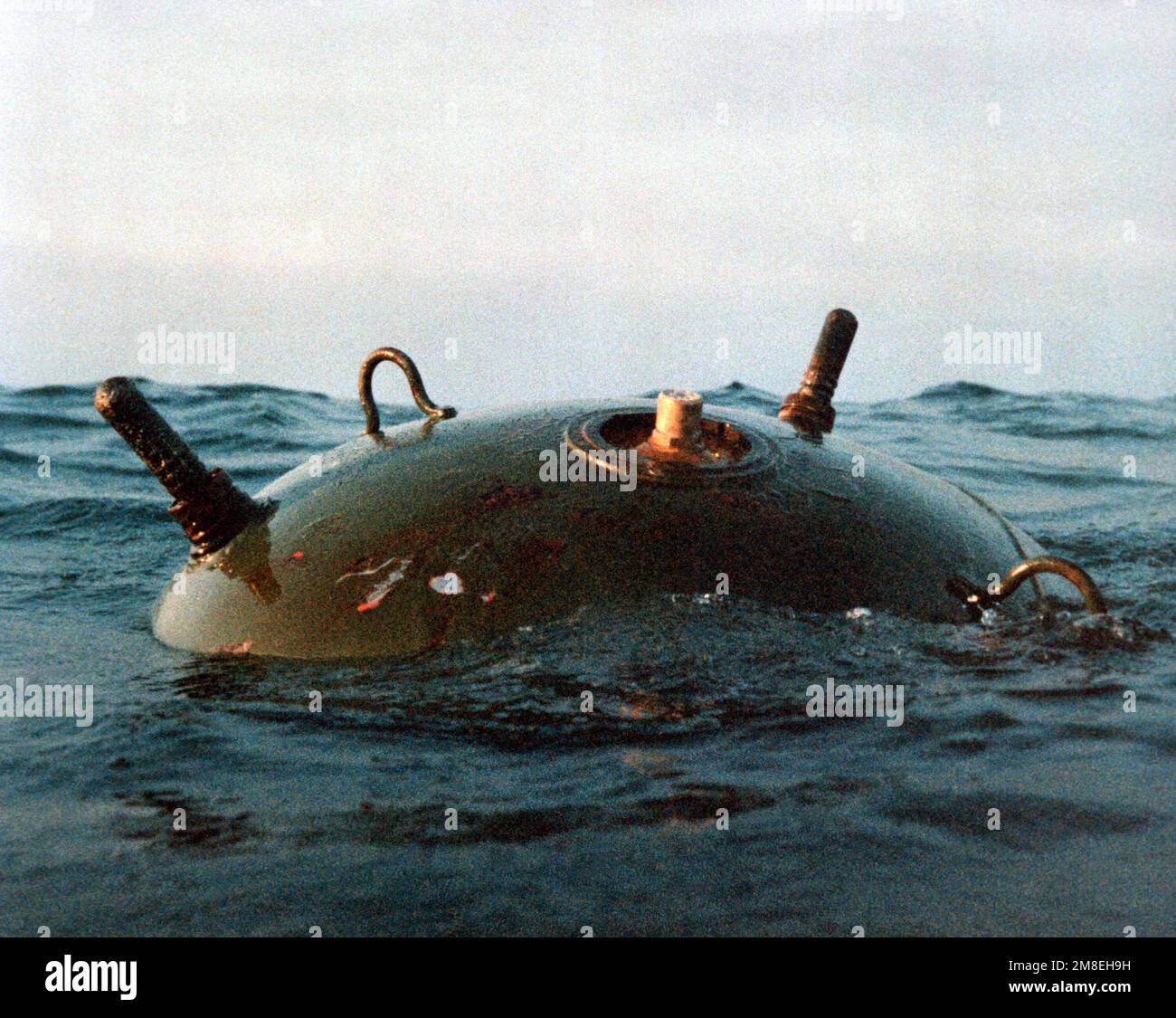 An Iraqi mine floats in the waters of the gulf. Over 1,275 such mines have been discovered in the gulf during Operation Desert Storm.. Subject Operation/Series: DESERT STORM Country: Unknown Stock Photo