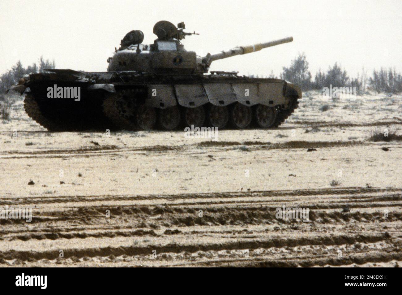 A damaged Iraqi T-72 main battle tank sits in the desert after being ...