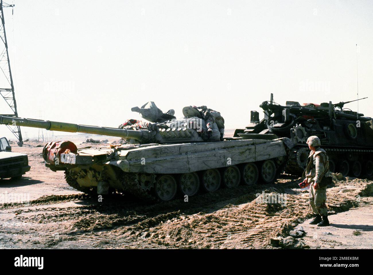 An M88A1 armored recovery vehicle is used to tow away an Iraqi T72