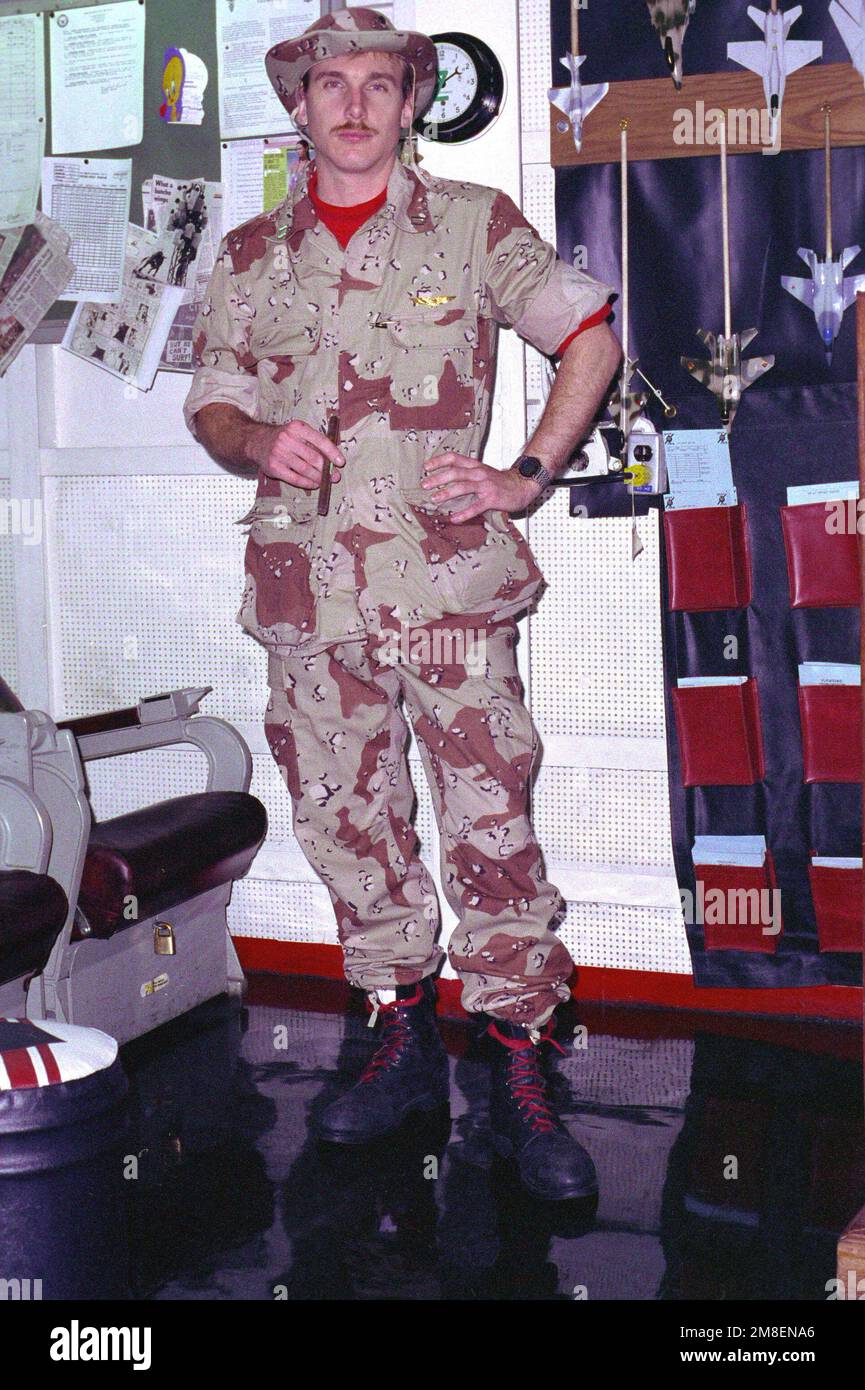 LT. Gerald B. Parsons, a radar intercept officer (RIO) with Fighter Squadron 41 (VF-41), stands in the squadron ready room aboard the nuclear-powered aircraft carrier USS THEODORE ROOSEVELT (CVN-71) during Operation Desert Storm.. Subject Operation/Series: DESERT STORM Country: Unknown Stock Photo