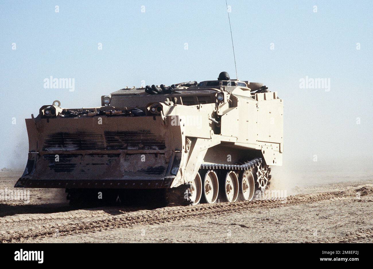 An M-9 Armored Combat Earthmover (ACE) assigned to the 2nd Marine Expeditionary Force moves toward the Kuwaiti border at the start of the ground phase of Operation Desert Storm. Subject Operation/Series: DESERT STORM Country: Saudi Arabia (SAU) Stock Photo