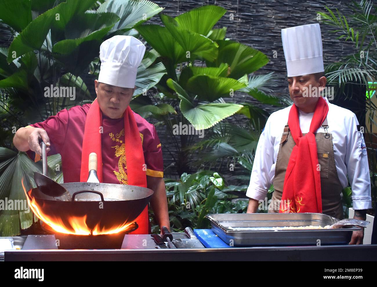 Havana, Cuba. 12th Jan, 2023. A Chinese chef (L) cooks at the