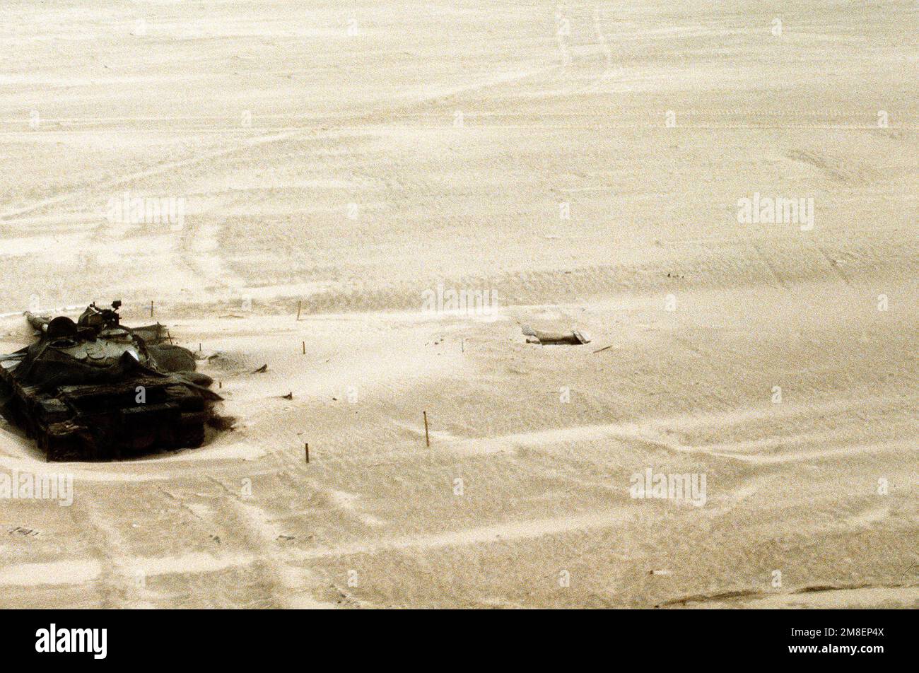 A disabled Iraqi T62 main battle tank partially covered with
