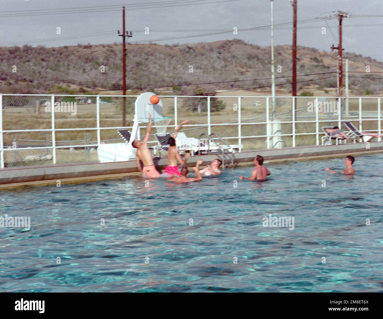 Off-duty servicemen play basketball in a pool aboard the naval station. Exact Date Shot Unknown. Base: Naval Station, Guantanamo Bay Country: Cuba (CUB) Stock Photo