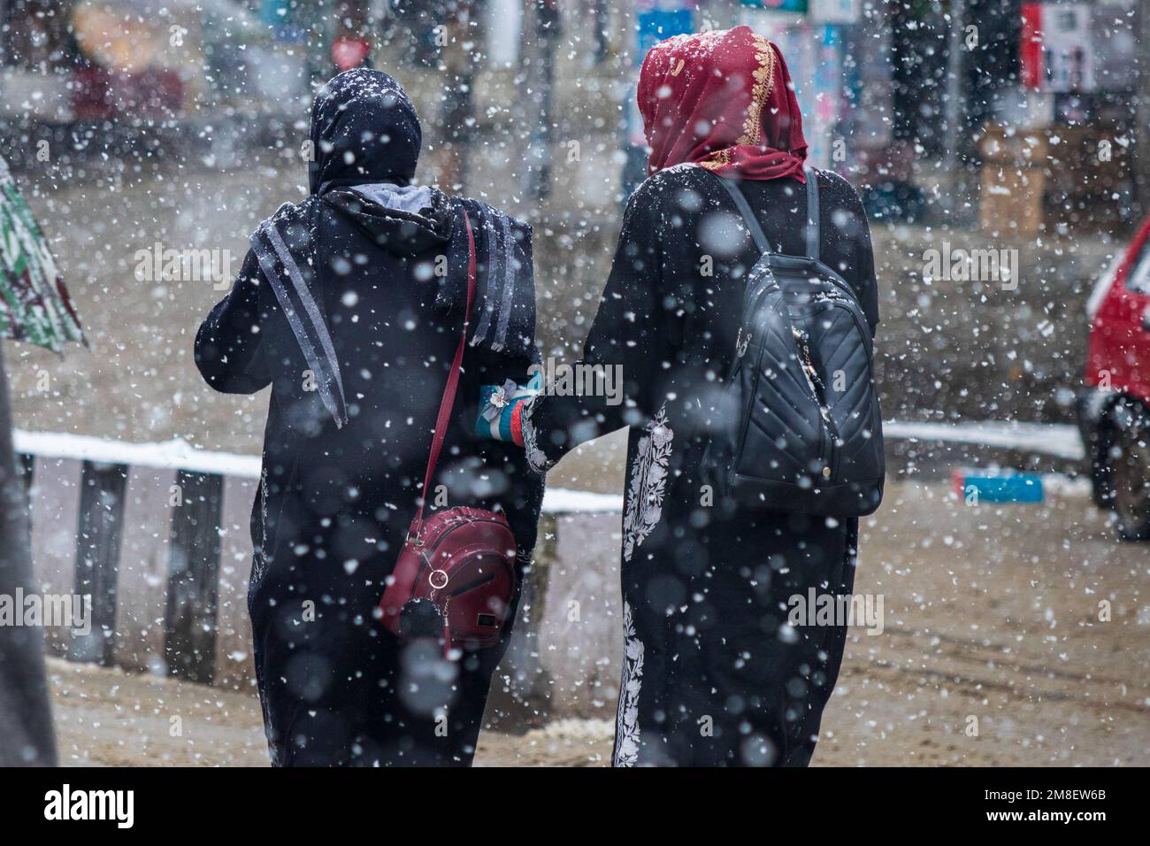 Students walk through a street amid ongoing heavy snowfall on the outskirts of Srinagar. At least two labourers killed on Thursday after an avalanche hits high-altitude area in central Kashmir's Sonamarg. Most parts of Kashmir received fresh snowfall that leading to the closure of Kashmir capital's main highway that connects disputed region with the rest of India. Meanwhile airport authorities suspended all flight operations till further notice due to continuous snowfall and low visibility. (Photo by Faisal Bashir/SOPA Images/Sipa USA) Stock Photo