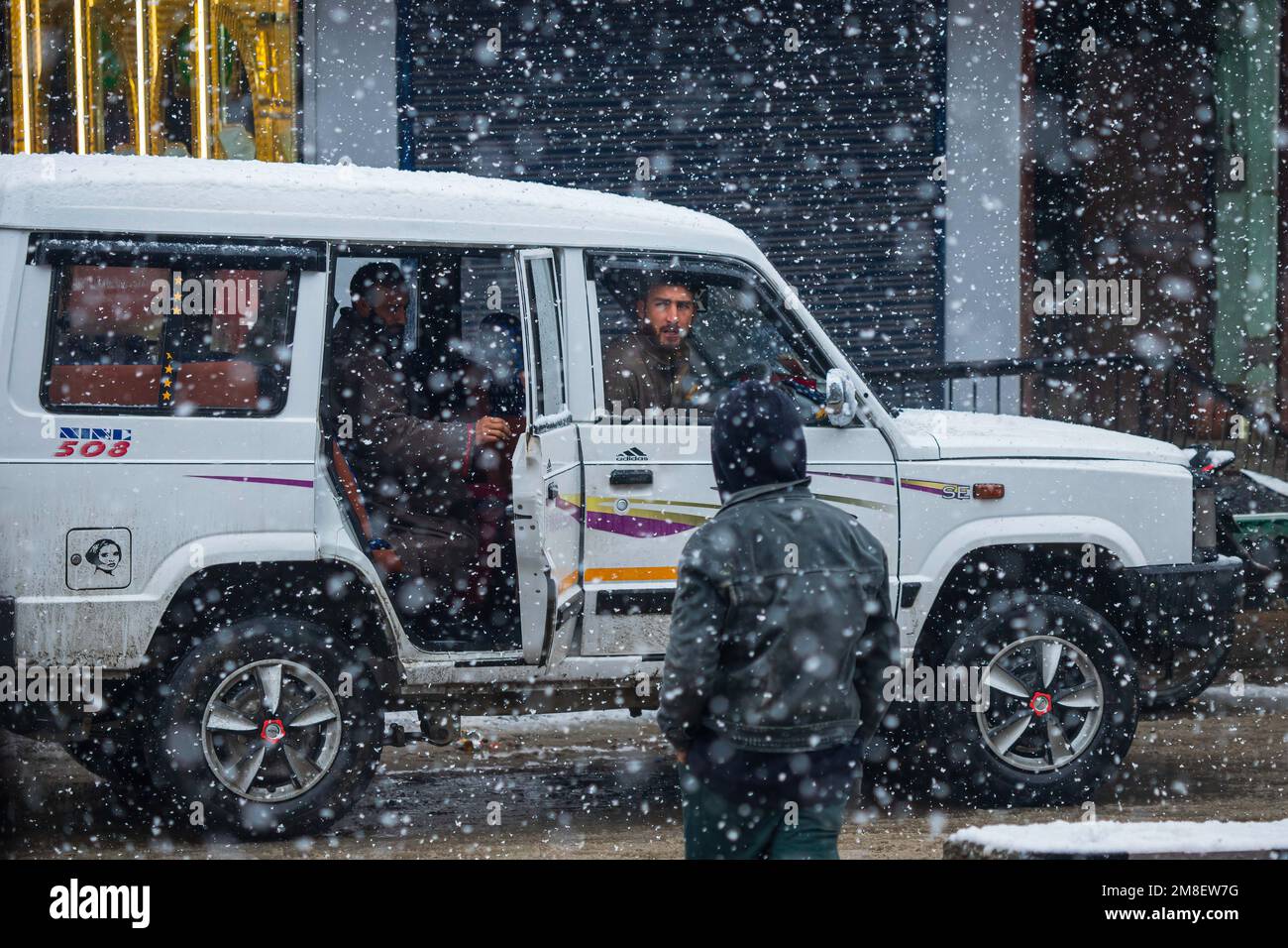 A cab driver waits for passengers amid ongoing heavy snowfall on the outskirts of Srinagar. At least two labourers killed on Thursday after an avalanche hits high-altitude area in central Kashmir's Sonamarg. Most parts of Kashmir received fresh snowfall that leading to the closure of Kashmir capital's main highway that connects disputed region with the rest of India. Meanwhile airport authorities suspended all flight operations till further notice due to continuous snowfall and low visibility. (Photo by Faisal Bashir/SOPA Images/Sipa USA) Stock Photo
