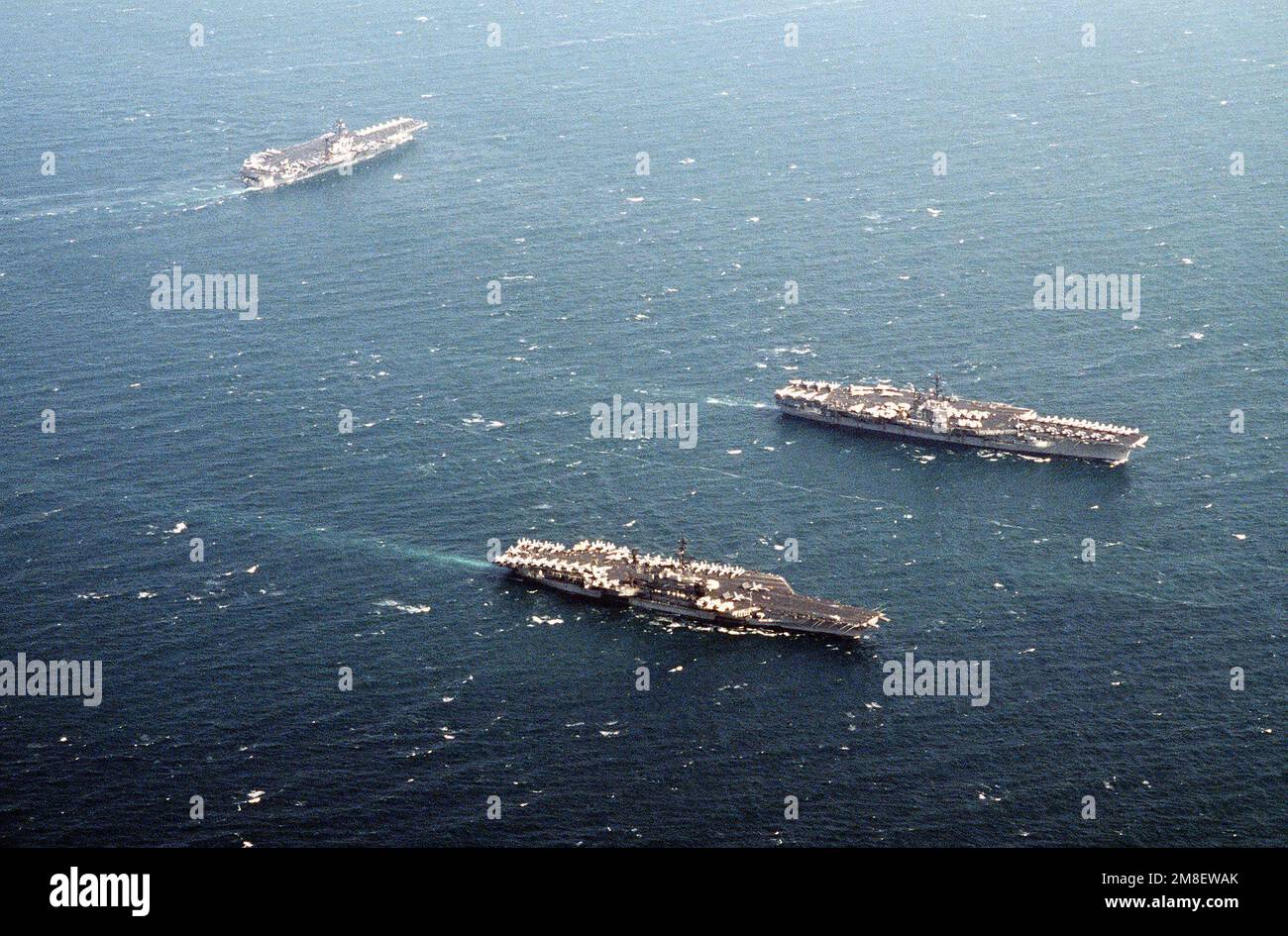 Three of four aircraft carriers comprising Battle Force Zulu travel in
