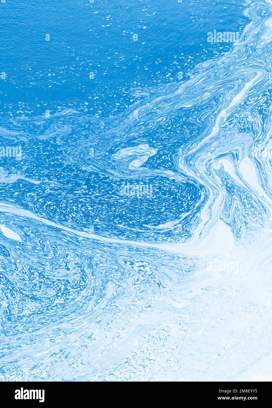Abstract of blue and white swirling water creating a smooth pattern for ...