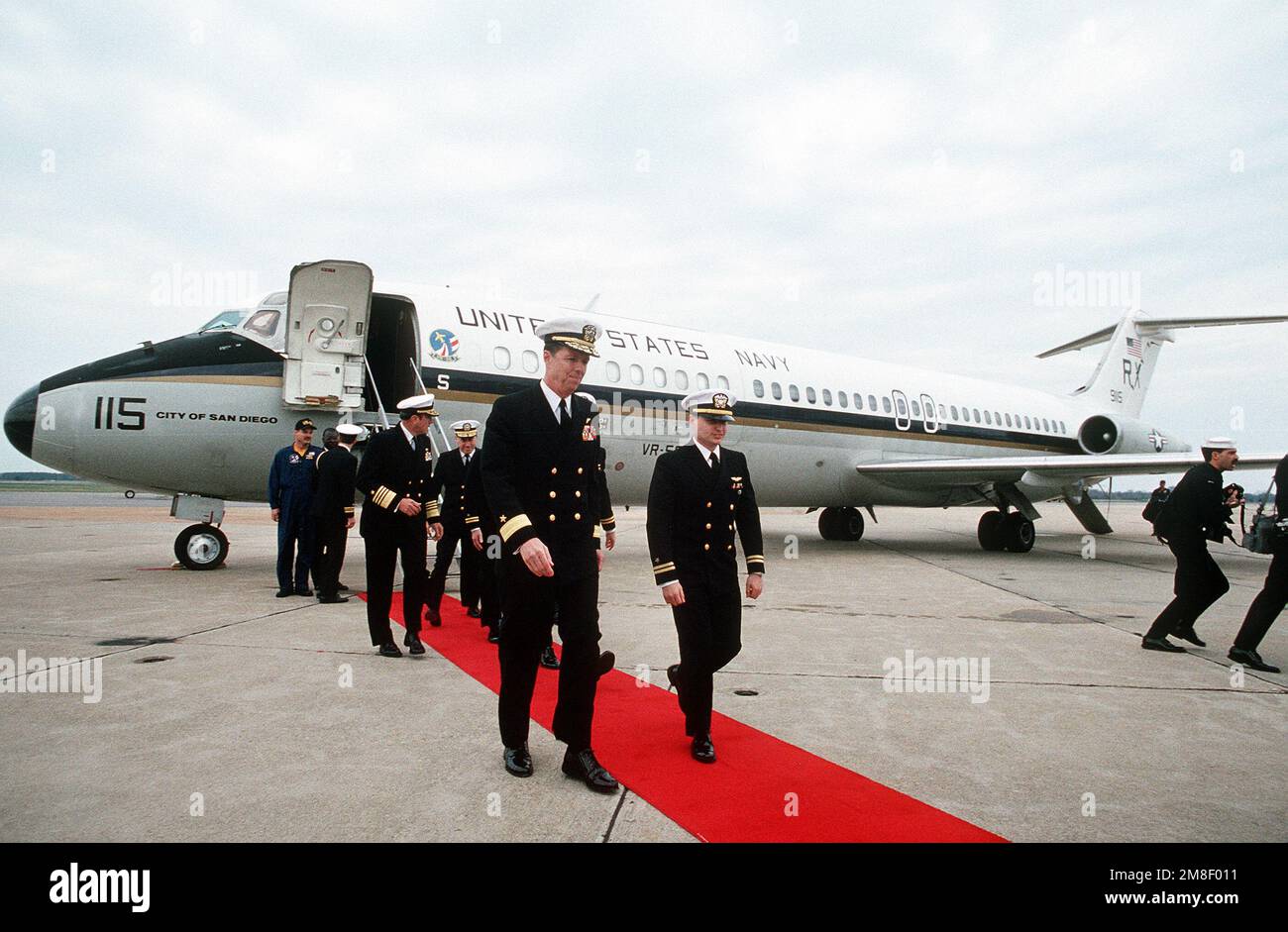 Rear Adm. (lower half) Paul W. Parcells, commander, Tactical Wings, Atlantic,  escorts LT. Robert Wetzel, LT. Lawrence Slade, and LT. Jeffrey Zaun down  the red carpet following their arrival by Fleet Logistics