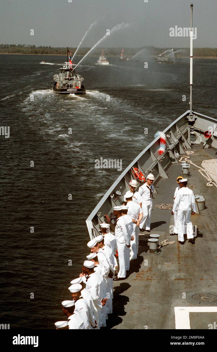 The large harbor tug NATCHITOCHES (YTB799) and other tugs spray