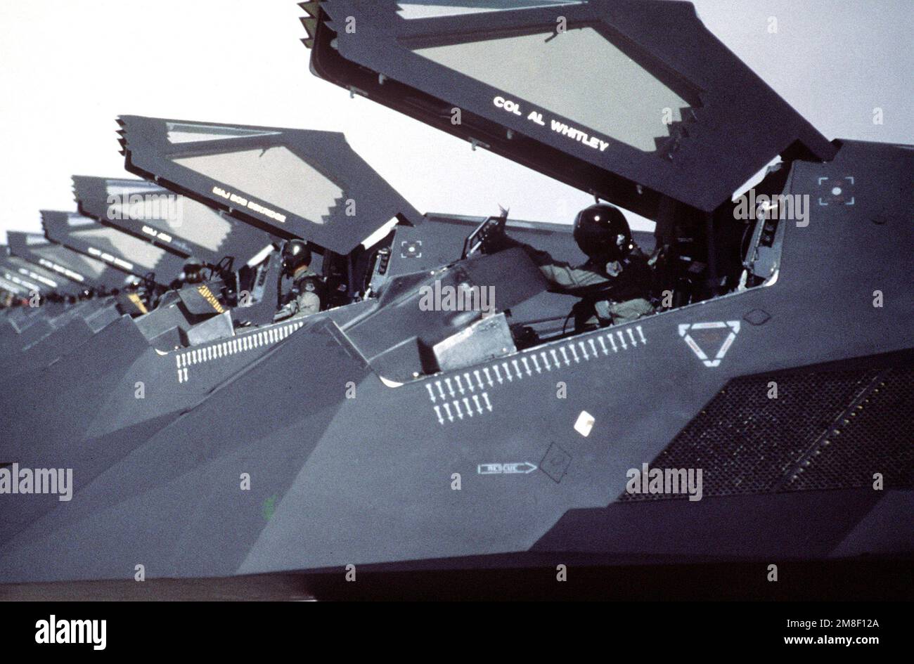 F-117 stealth fighter aircraft of the 37th Tactical Fighter Wing stand on the flight line with canopies raised following their return from Saudi Arabia where they took part in Operation Desert Storm.. Subject Operation/Series: DESERT STORM Base: Nellis Air Force Base State: Nevada(NV) Country: United States Of America(USA) Stock Photo