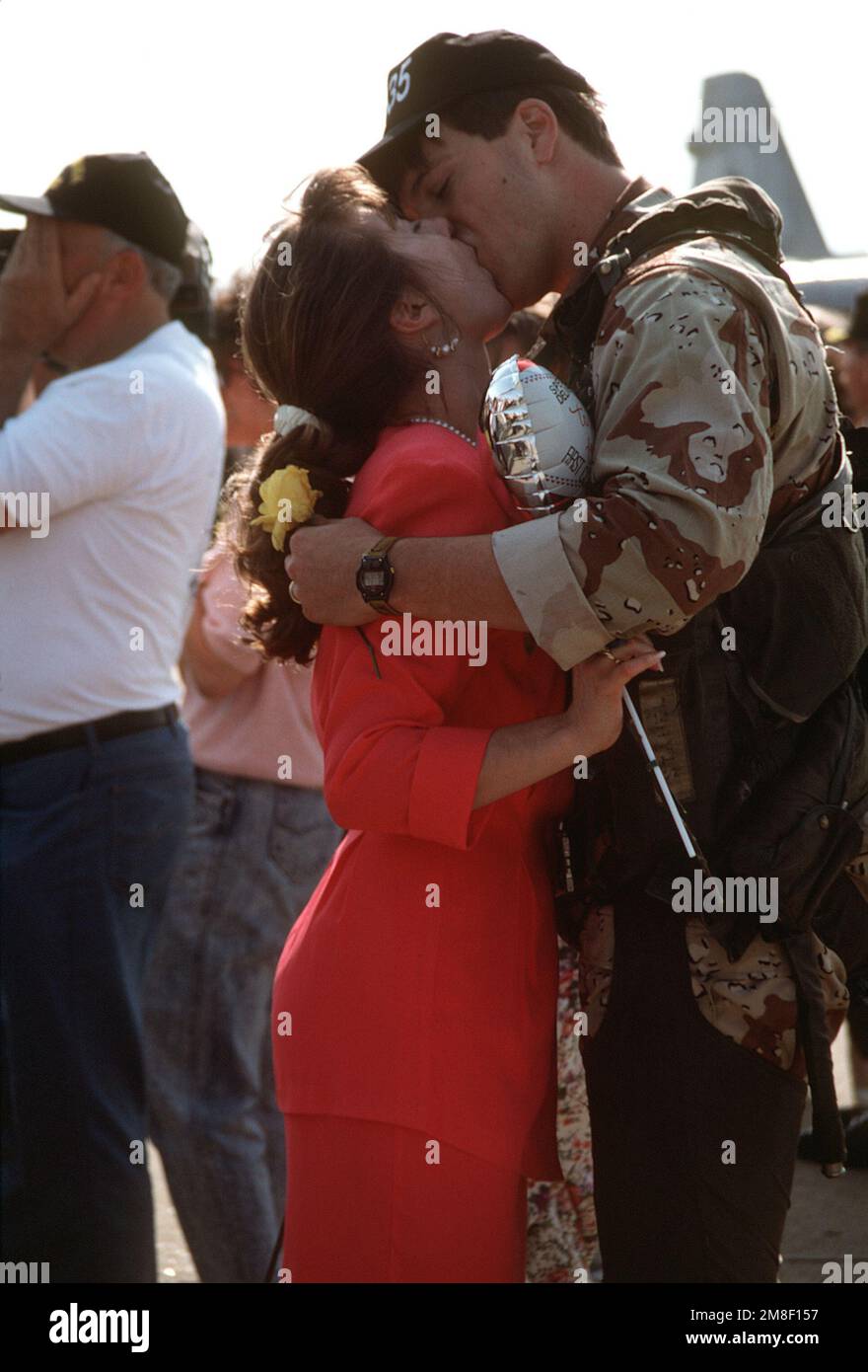 A pilot from Attack Squadron 35 (VA-35) kisses his wife as they are reunited upon the squadron's arrival at the air station. VA-35 has returned to Oceana following its deployment to the Persian Gulf region aboard the aircraft carrier USS SARATOGA (CV-60) for Operation Desert Shield and Operation Desert Storm. Subject Operation/Series: DESERT STORMDESERT STORM Base: Naval Air Station, Oceana State: Virginia(VA) Country: United States Of America (USA) Stock Photo
