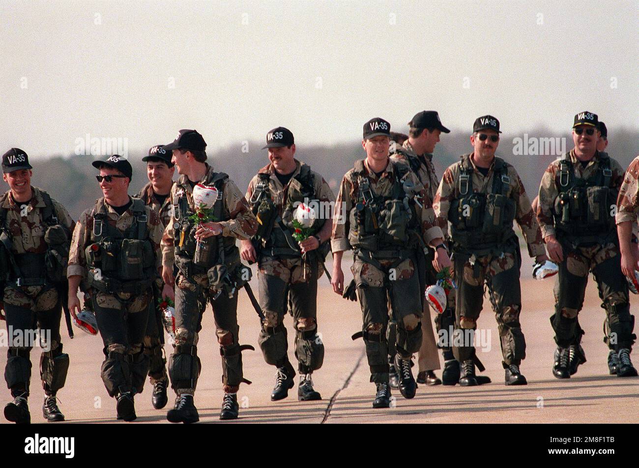 The pilots and bombardier-navigators of Attack Squadron 35 (VA-35) walk together across the flight line toward the crowd gathered to meet them. VF-35 has returned to Oceana following its deployment to the Red Sea aboard the aircraft carrier USS SARATOGA (CV-60) for Operation Desert Shield and Operation Desert Storm. Subject Operation/Series: DESERT STORMDESERT SHIELD Base: Naval Air Station, Oceana State: Virginia (VA) Country: United States Of America (USA) Stock Photo