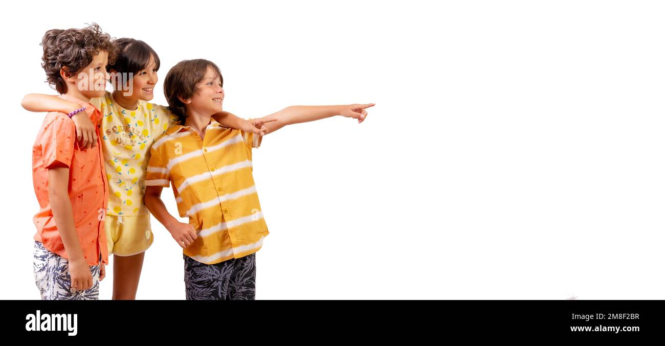 Caucasian kids hugging and pointing to the right, summer vacation concept. White background Stock Photo