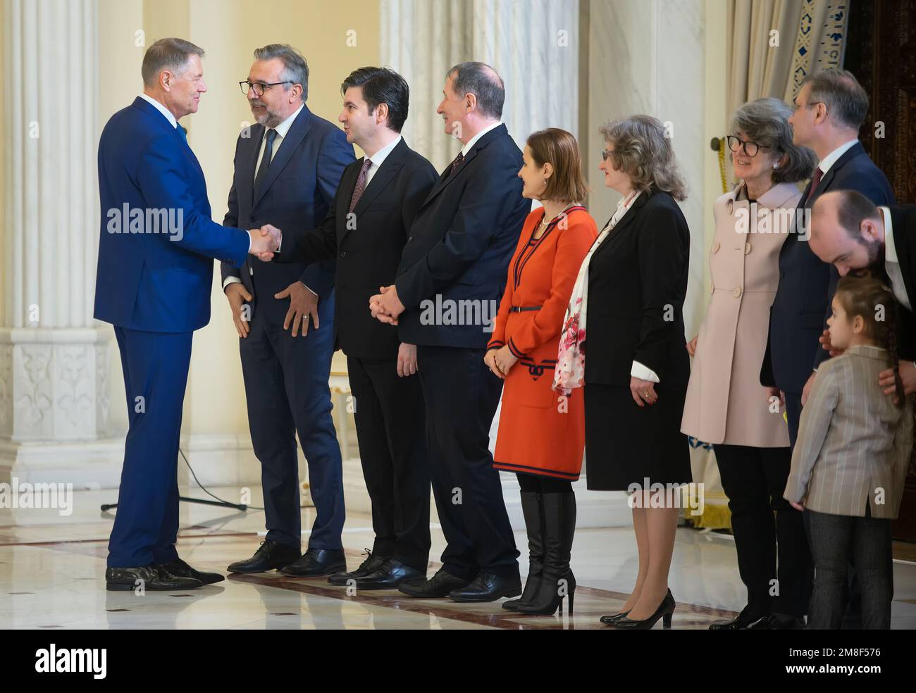 Bucharest, Romania - January 13, 2023: President of Romania Klaus Iohannis shakes hands with Liviu Sebastian Jicman at the National Culture Day decora Stock Photo