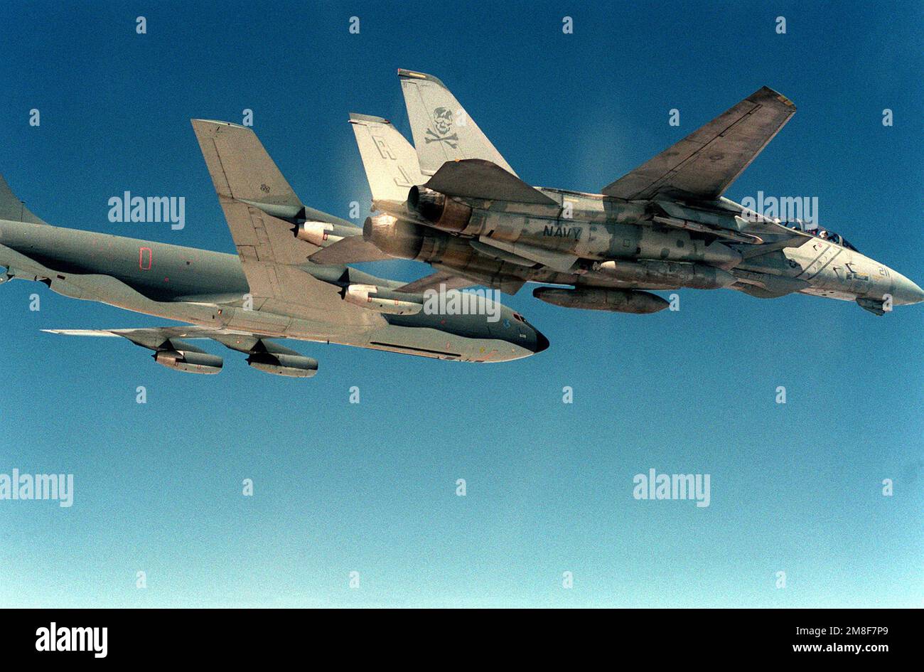 A Fighter Squadron 84 (VF-84) F-14A Tomcat aircraft flies beside