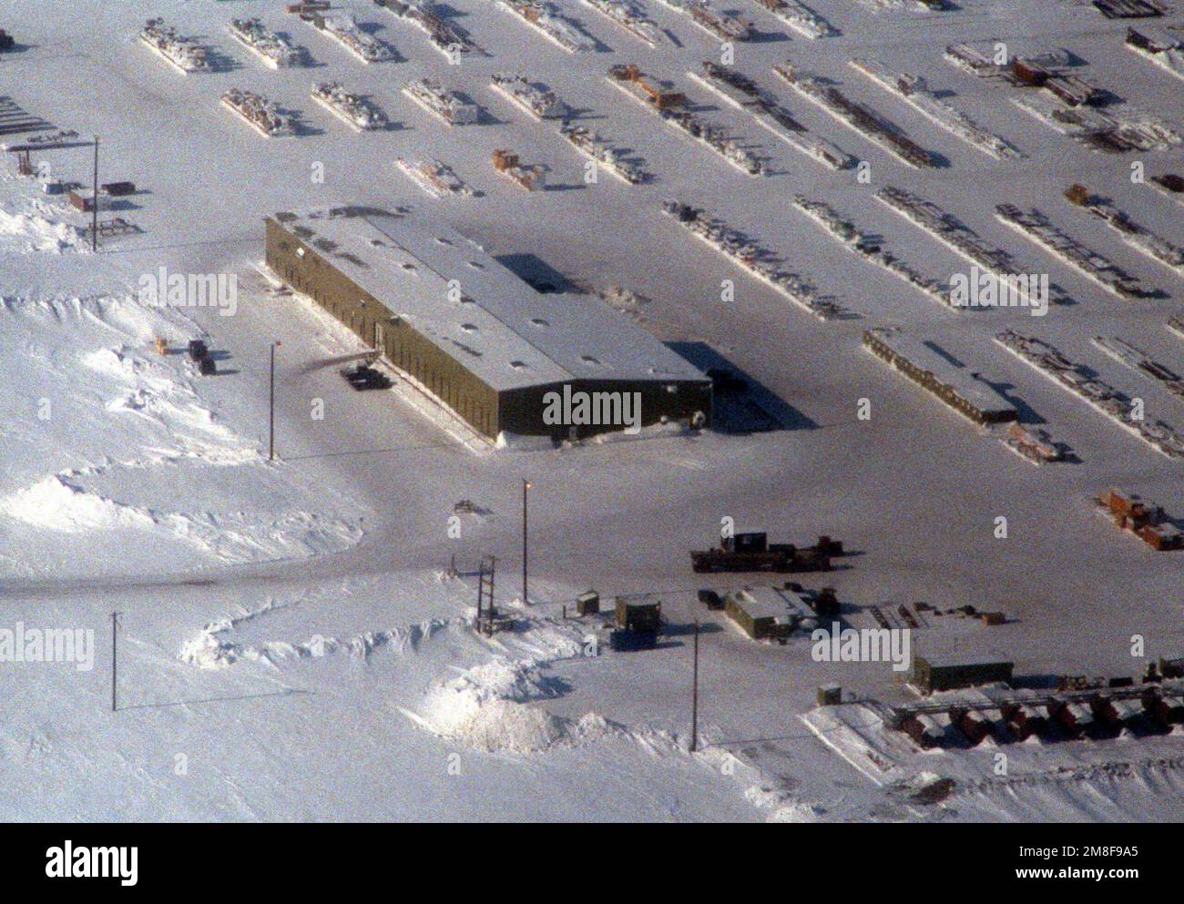 An aerial view of a building and a staging area at an unidentified