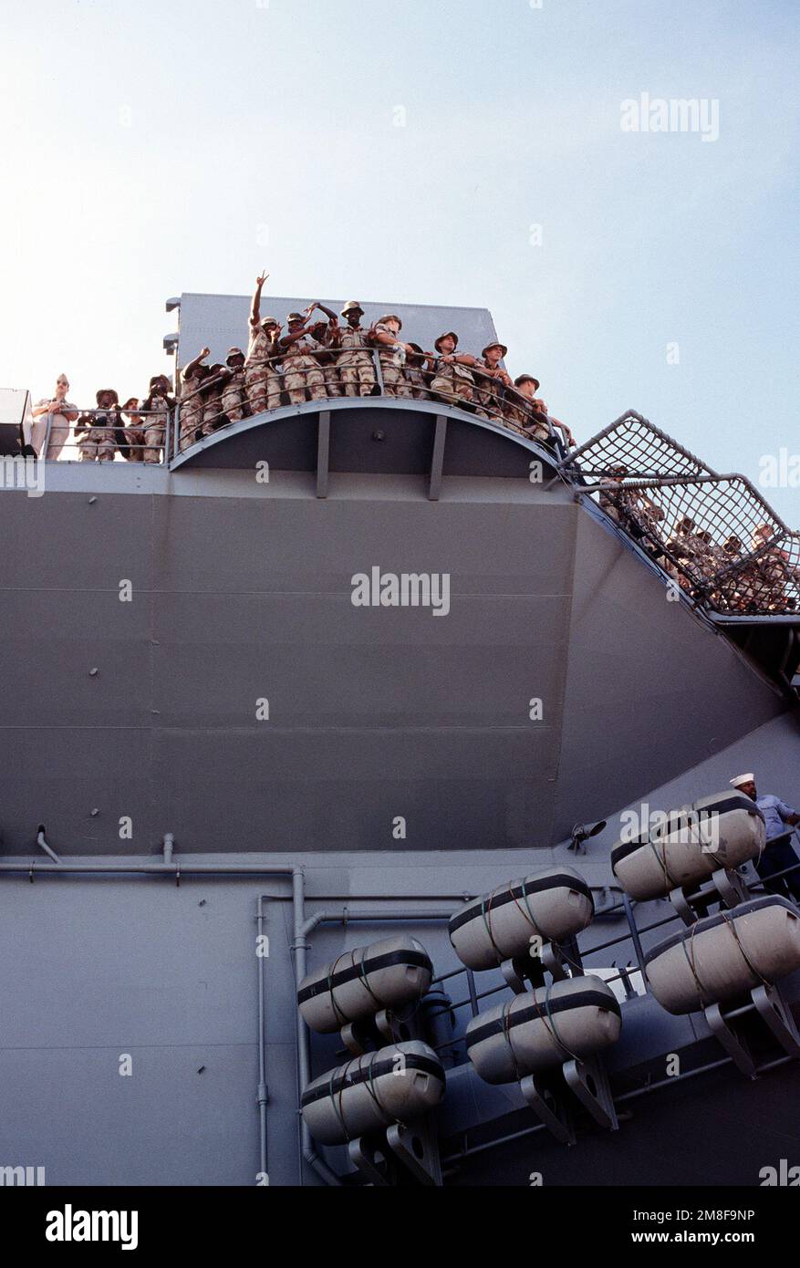 Marines from the 4th Marine Expeditionary Brigade (4th MEB) crowd along ...