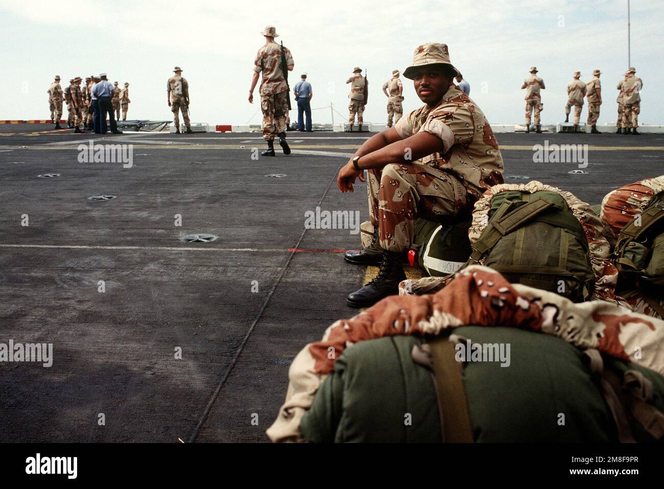 A Marine from the 4th Marine Expeditionary Brigade (4th MEB) sits on a ...
