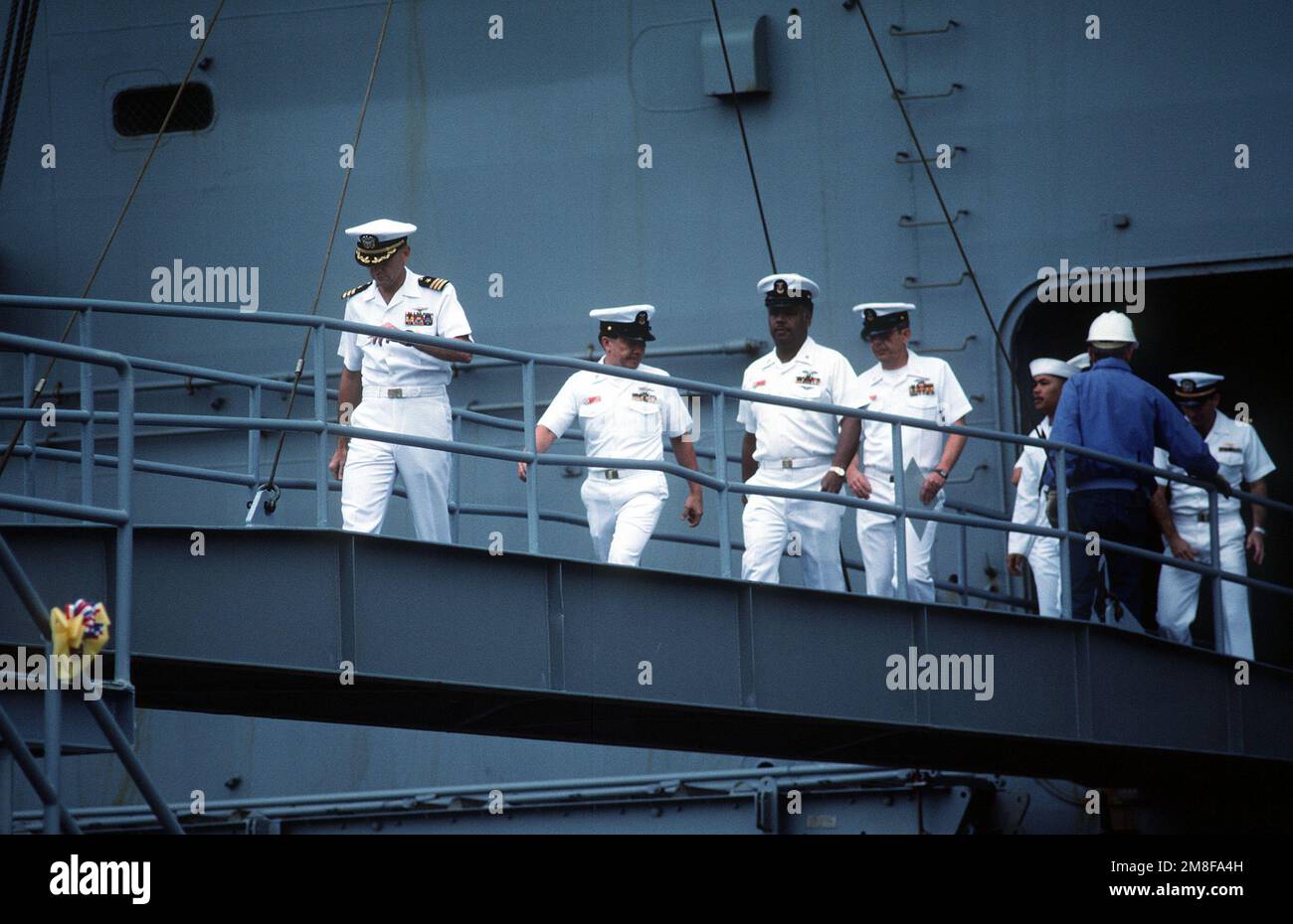 Crew members come ashore from the amphibious assault ship USS OKINAWA ...