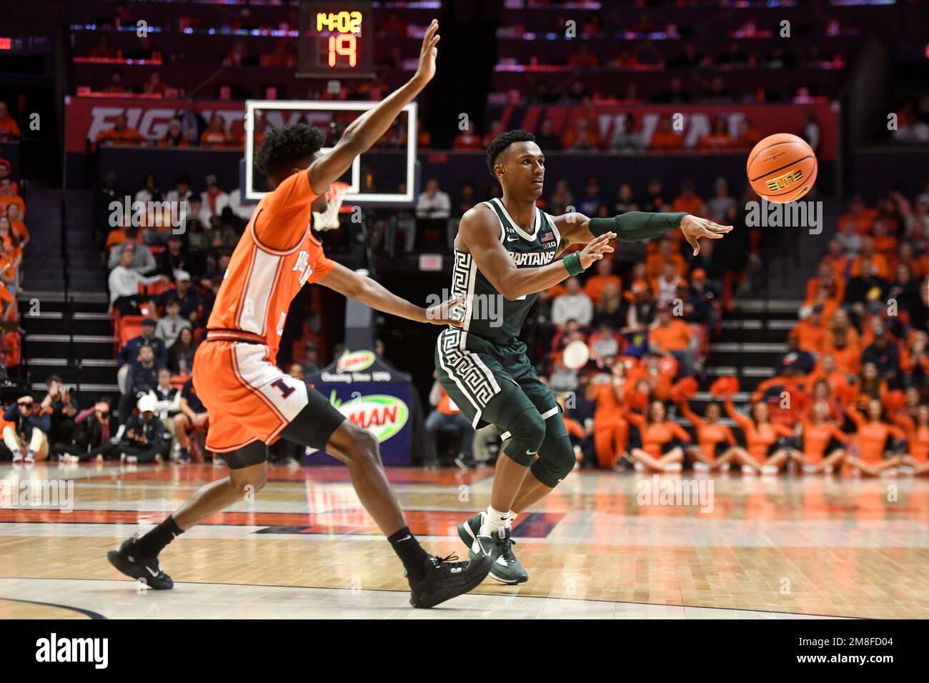 Michigan State's Tyson Walker, right passes the ball as Illinois ...