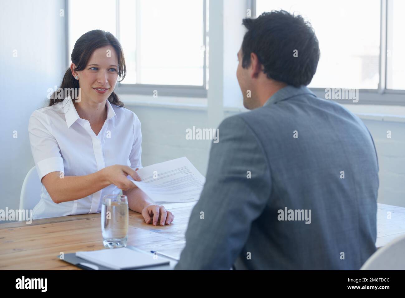 Sure to get the job A pretty young - Sure To Get The Job A Pretty Young Woman Handing Her Resume To A Prospective Employer At A Job Interview 2M8FDCC 