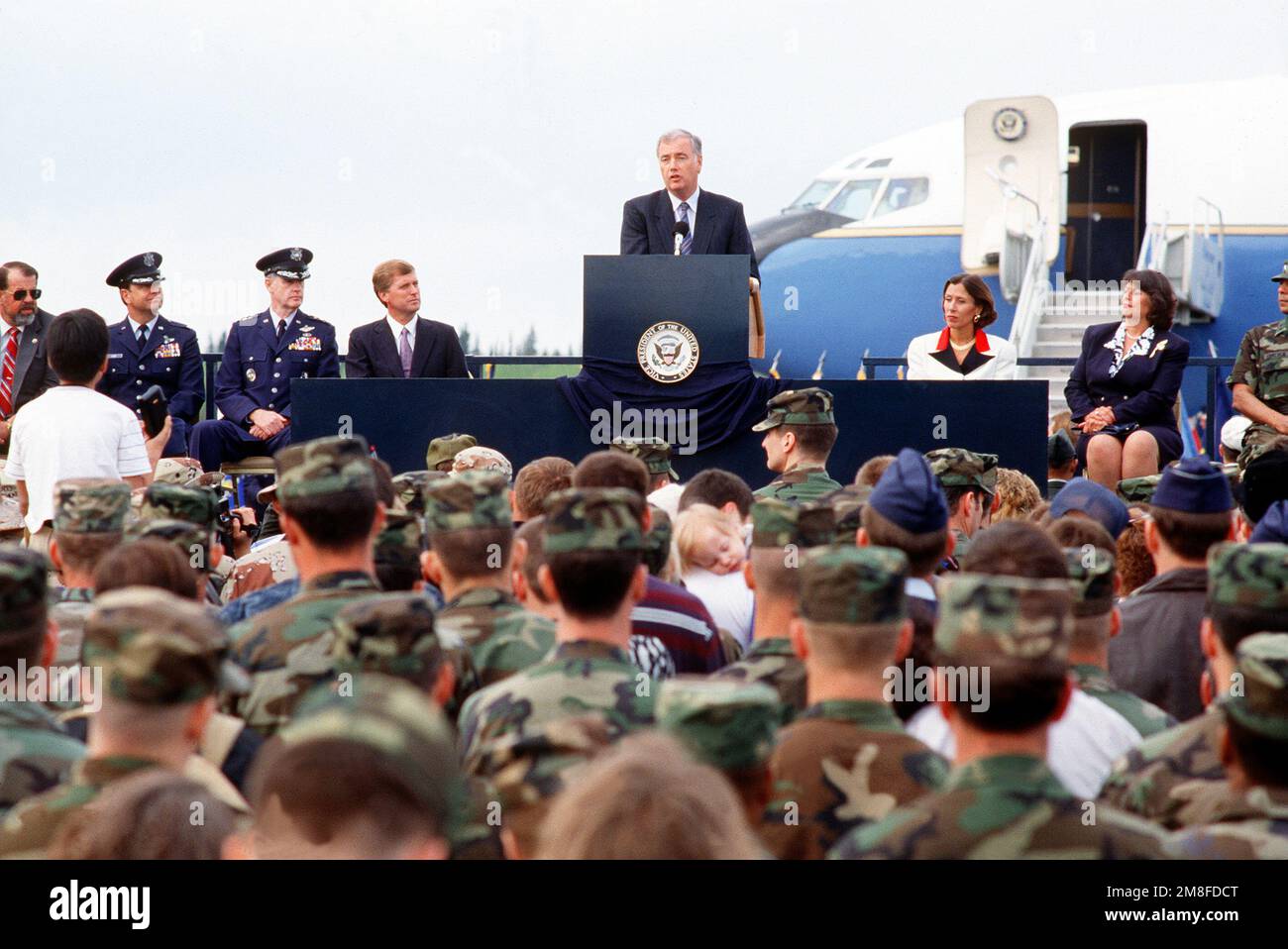 Alaskan Sen. Frank H. Murkowski speaks to troops assembled at Eielson for a visit by Vice President J. Danforth Quayle, seated at left. Seated beside Quayle is LT. GEN. Thomas G. McInerney, commander, 11th Air Force, while Marilyn Quayle and Mrs. Murkowski are seated at right. The vice president is visiting Eielson to express his appreciation to airmen who served in the Persian Gulf area during Operation Desert Storm. Subject Operation/Series: DESERT STORM Base: Eielson Air Force Base State: Alaska(AK) Country: United States Of America(USA) Stock Photo