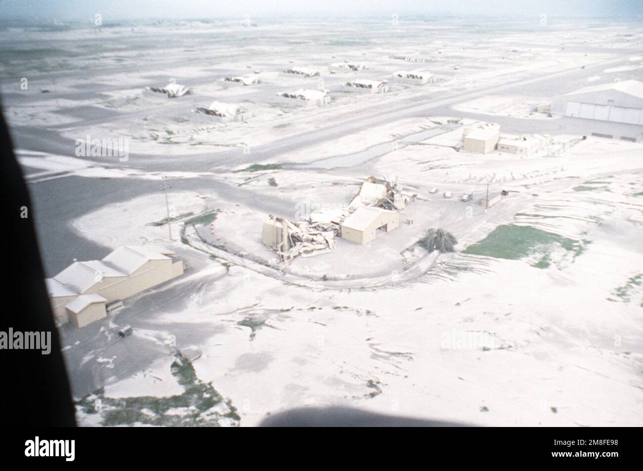 Aerial view shows the destroyed fuel systems maintenance dock and aircraft weather shelters after more than four inches of volcanic ash fell as a result of the June 10 eruption of Mount Pinatubo. More than 20,000 evacuees have been removed from the area as a part of the U.S. military's Operation Fiery Vigil. Subject Operation/Series: FIERY VIGIL Base: Clark Air Base State: Luzon Country: Philippines(PHL) Stock Photo