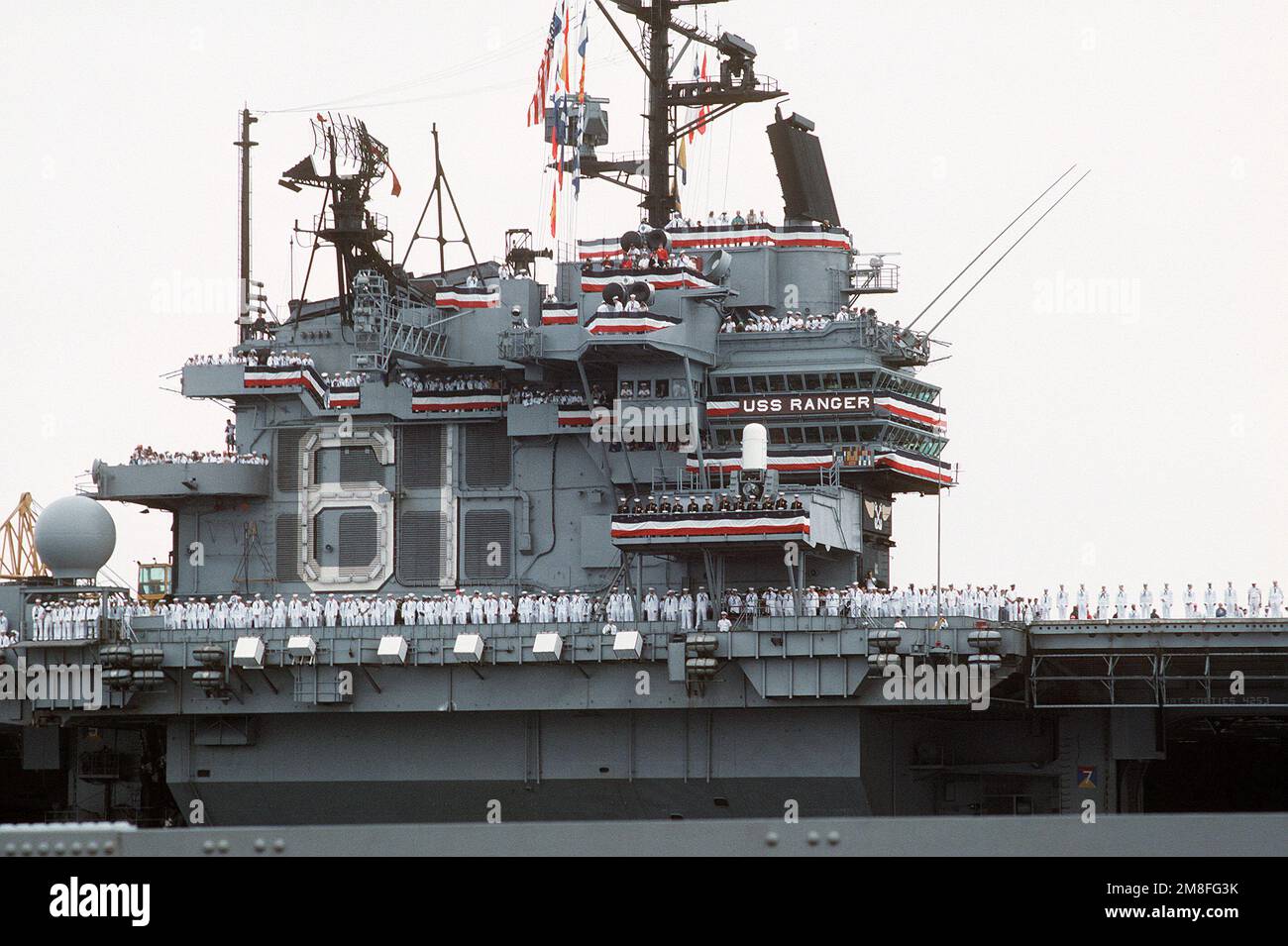 Crew members man the rails aboard the aircraft carrier USS RANGER (CV ...