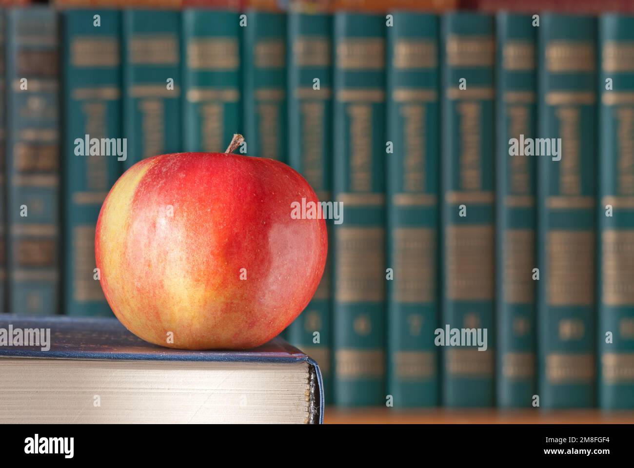 An old book with a red apple Stock Photo