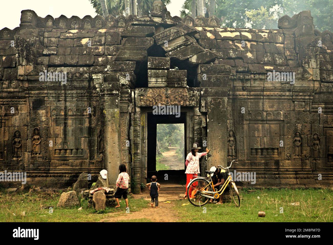 A local family having leisure time at Banteay Prei Nokor temple, a cultural heritage that is archaeologically dated back to the 11th century, located in Kompong Cham (Kampong Cham), Cambodia. The temple is rarely visited by tourist. 'The sustainability of cultural heritage resources is strongly linked to the effective participation of local communities in the conservation and management of these resources,' wrote a team of scientists led by Sunday Oladipo Oladeji in the abstract of their paper published on Sage Journals on Oct 28, 2022. Stock Photo