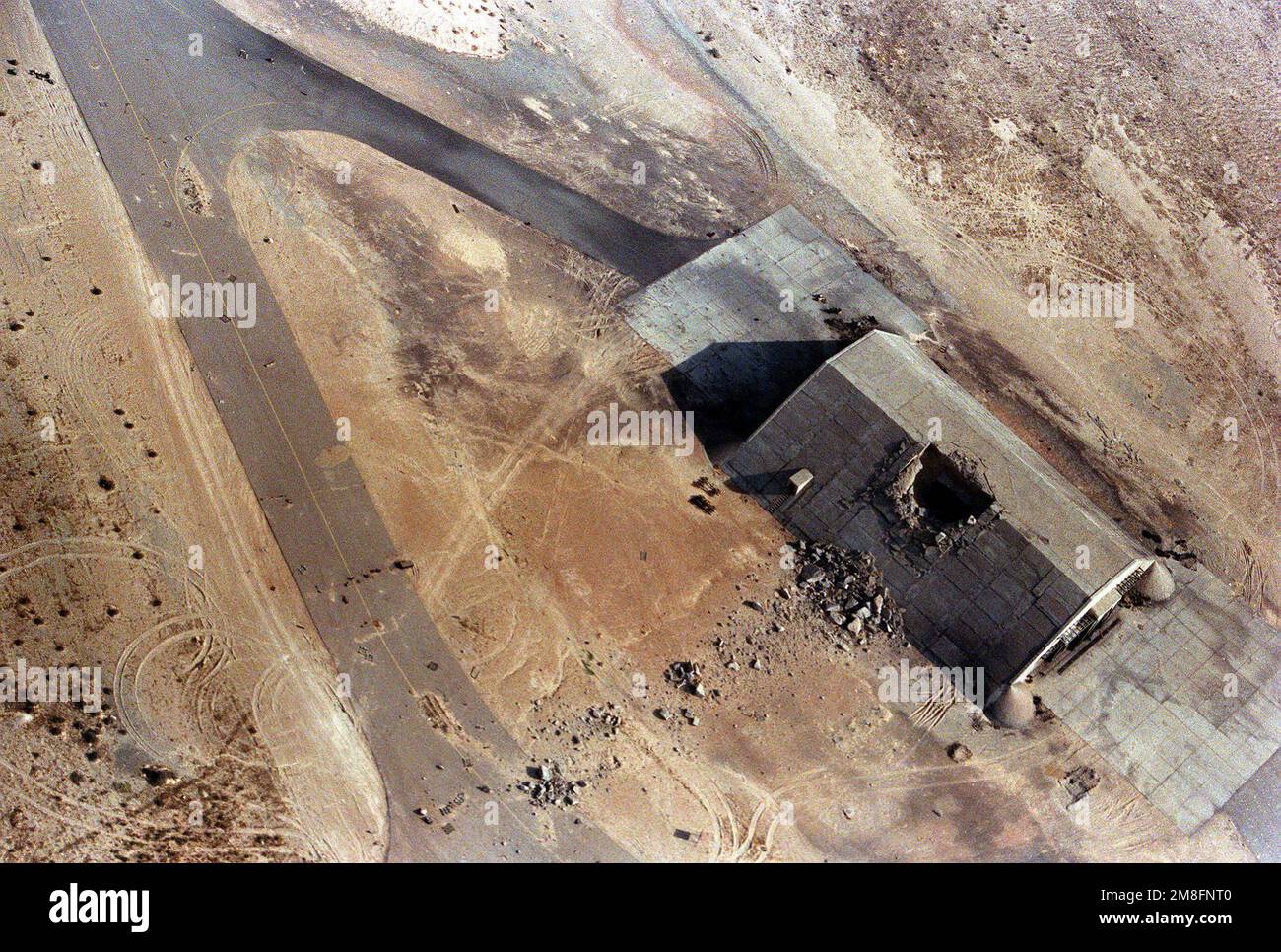 An aerial view of a destroyed aircraft hangar in the aftermath of Operation Desert Storm