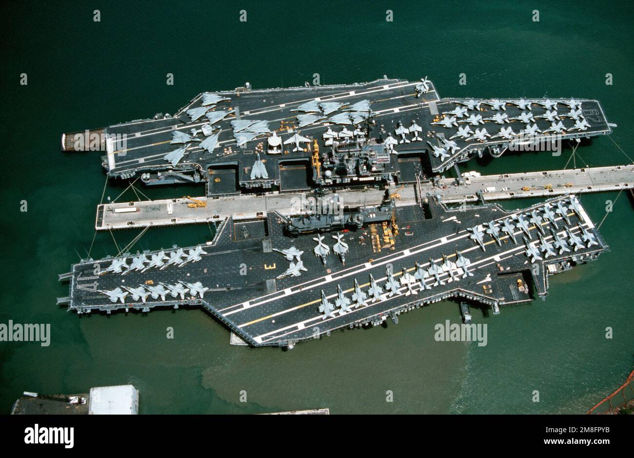 An aerial view of various aircraft lining the flight decks of the ...