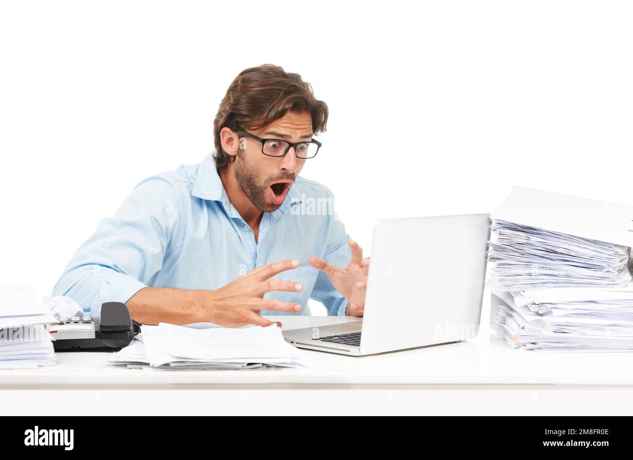 Laptop, paperwork and businessman with shock after reading information online in studio. Shocked, surprise and professional male employee with wtf or Stock Photo