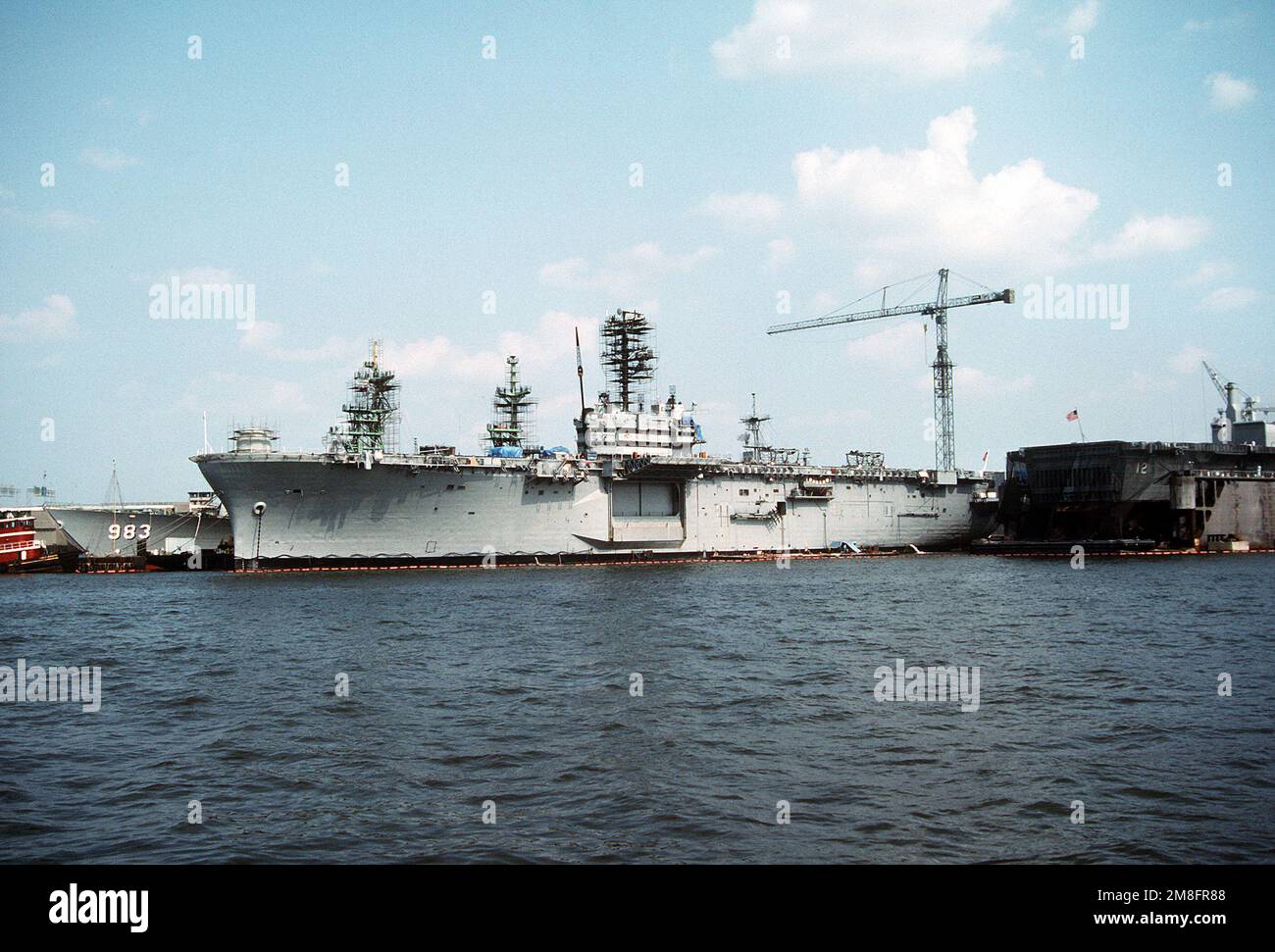 The amphibious assault ship USS IWO JIMA (LPH2), center, lies tied up