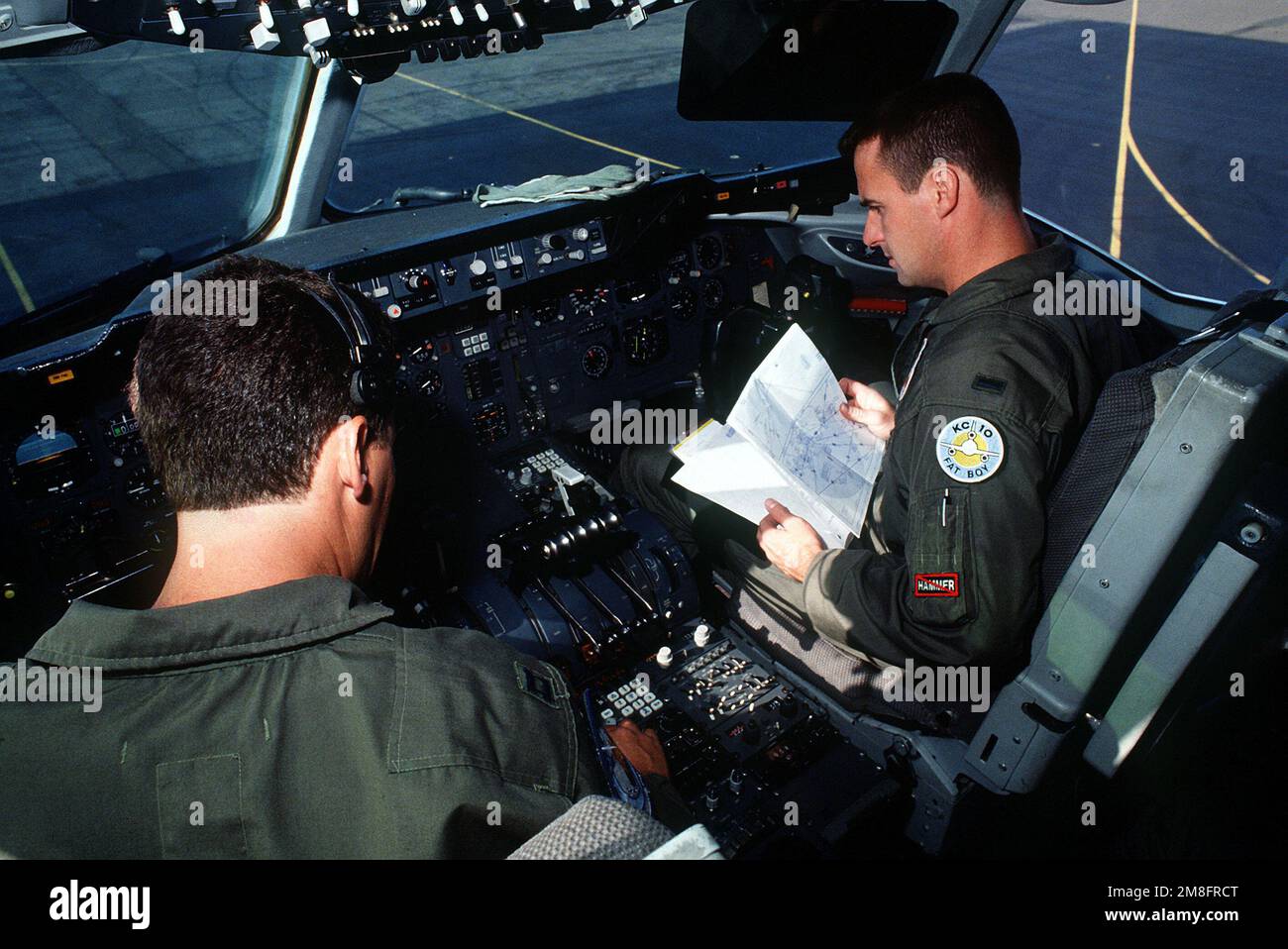 CAPT. Richard Berger, left, aircraft commander, and 1ST LT. Mike Mathews perform a preflight inspection in the cockpit of a KC-10A Extender aircraft during a Military Airlift Command channel cargo mission. Both are with the 6th Air Refueling Squadron, 22nd Air Refueling Wing. Base: Andersen Air Base State: Guam (GU) Country: United States Of America (USA) Stock Photo
